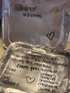 An aluminum pan cover with a heartfelt message written on it.