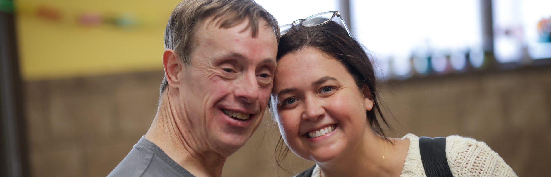 A man and a woman smiling next to each other.